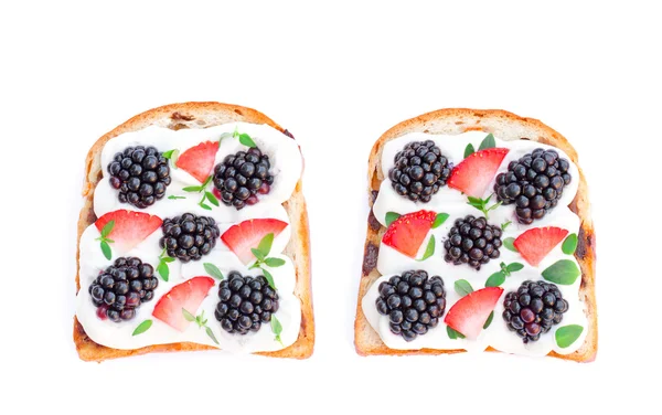 Slices of bread with cream cheese berries and basil isolated on — Stock Photo, Image