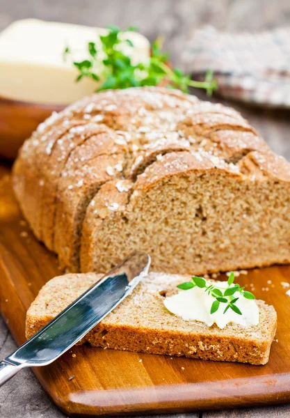 Sliced Irish stoneground soda bread with butter and thyme on the — Stock Photo, Image