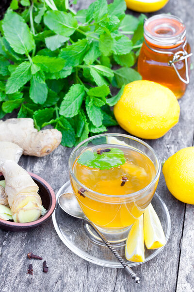 Herbal tea with lemon and ginger on wooden table