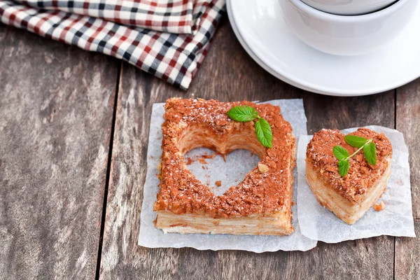 Heart  shaped  napoleon cake with mint on old wooden table — Stock Photo, Image