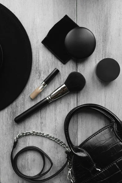 Topi, kuas, tas tangan untuk makeup dan bubuk pada latar belakang kayu ringan — Stok Foto