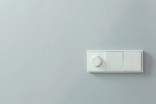 Installation of switches and controls for lighting on a white wall — Stock Photo, Image