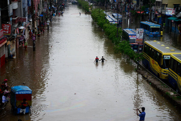 Citizens and Vehicles try to moves through the waterlogged streets of Dhaka after heavy rainfalls caused almost-standstill, on June 1, 2021. After monsoon heavy rains caused waterlogged most of area in the capital city of Dhaka in Bangladesh.