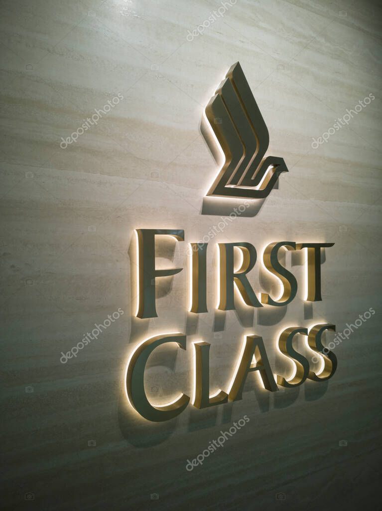Singapore - 24 Sep, 2025: The iconic SIA Logo, a golden bird in flight, is prominently displayed at a sleek and modern entrance of Singapore Airlines First Class Check-in Reception, customers can use its private check-in facility