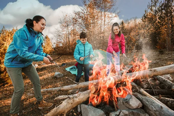 Happy family on a camping trip. Family doing camping in the forest