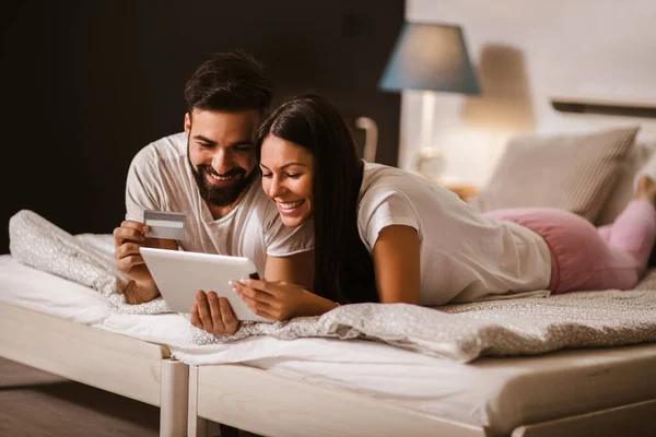 Pareja Joven Compras Línea Desde Comodidad Del Dormitorio Uso Tabletas — Foto de Stock