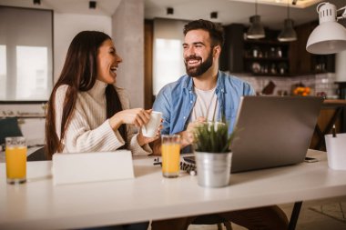 Mutlu çift işten zevk alıyor. Mutlu çift evde dizüstü bilgisayarla iş yapıyor..