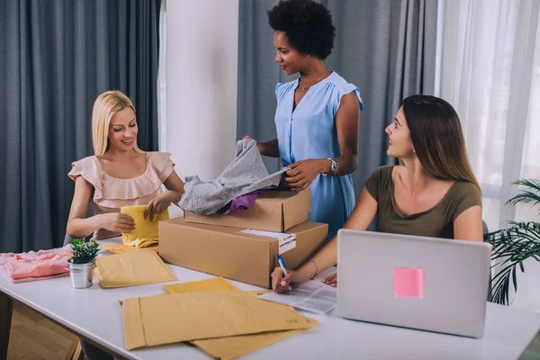 Sales online.Three young  women helped sell their products online and happily prepared to delivery their products. Selling products online or doing freelance work at home concept.