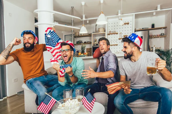 Emocionados Amigos Masculinos Animando Mientras Ven Partido Fútbol Americano Sofá —  Fotos de Stock