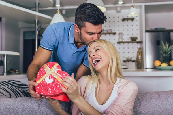 一对年轻貌美的情侣在家中情投意合 用礼品盒交换庆祝 — 图库照片