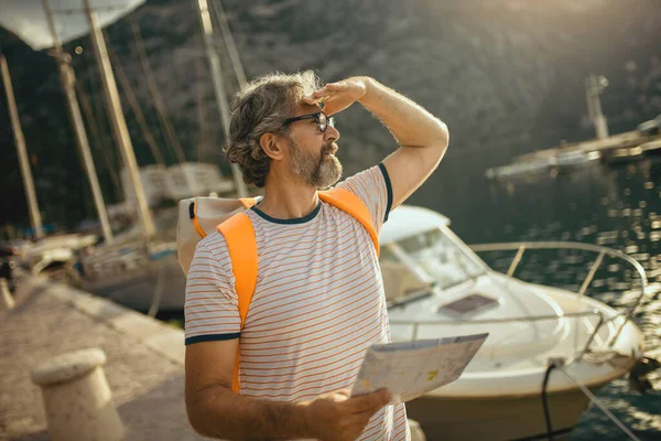 Gülümseyen Turist Olgun Bir Adam Harita Sırt Çantasıyla Denizin Kenarında — Stok fotoğraf