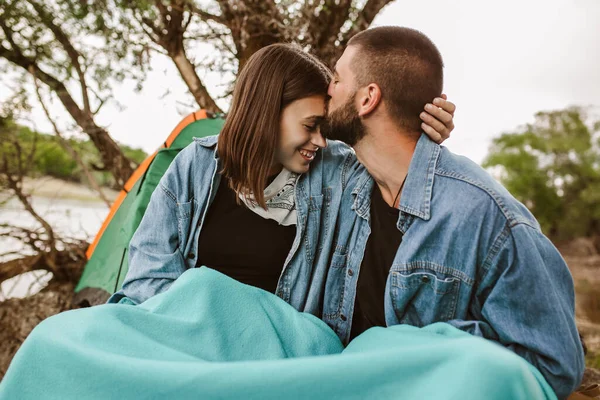 Happy couple on a romantic camping vacation.