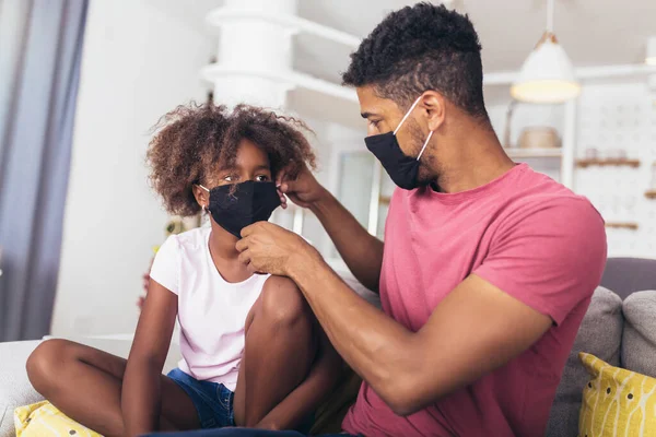 Father Medical Mask Puts Protective Mask His Daughter Home Kid — Stock Photo, Image