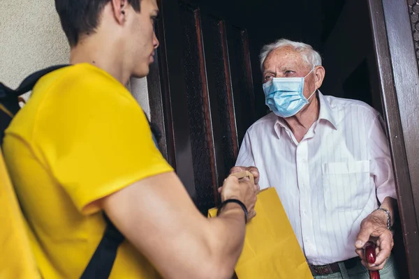 Junge Männliche Freiwillige Maske Liefern Einkäufe Einen Älteren Mann Spende — Stockfoto