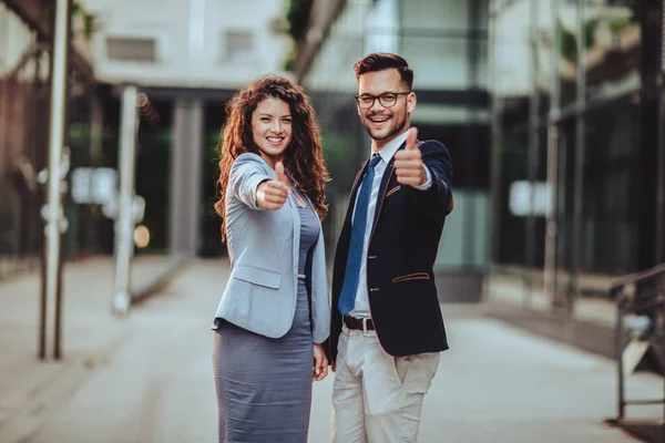 屋外で親指を立てているビジネス女性とビジネスマン — ストック写真