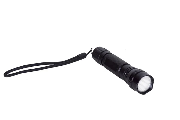 Black flashlight on white background. — Stock Photo, Image
