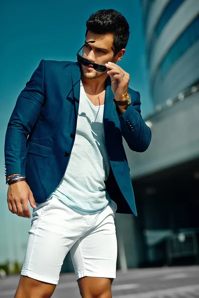 High fashion look.Young stylish confident happy handsome  businessman model man in blue suit cloth lifestyle in the street in sunglasses behind sky — Stock Photo, Image