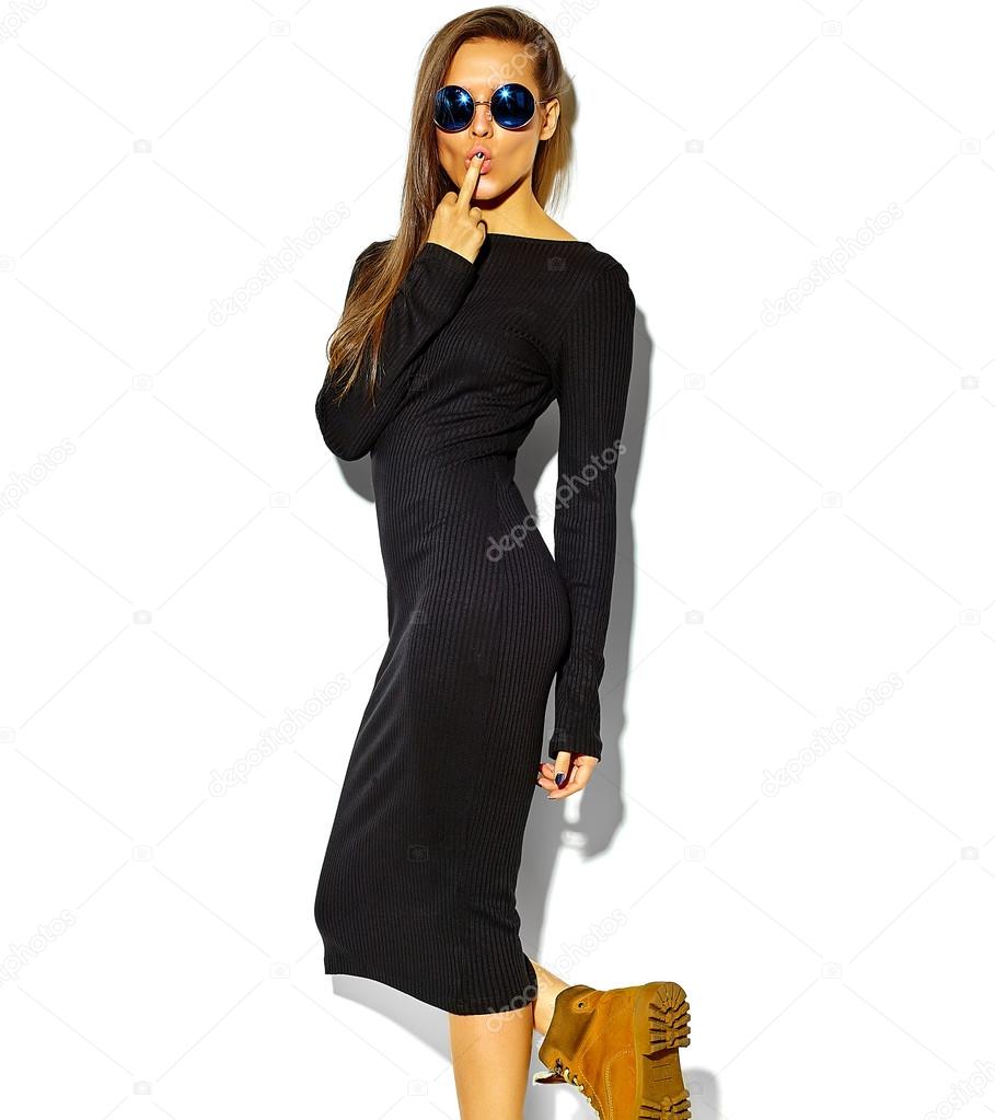 beautiful happy cute smiling brunette woman girl in casual black hipster summer clothes with no makeup isolated on white in sunglasses, showing fuck off sign