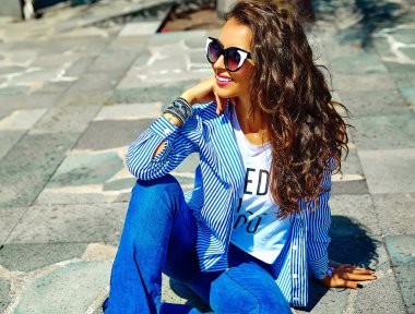 yaz hipster rahat mavi giysiler güneş gözlüğü sokakta oturan moda şık güzel genç gülümseyen esmer kadın model