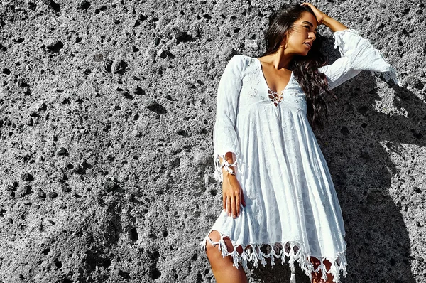 Photo of sensual sexy beautiful young brunette hippie model girl  in white dress posing outdoor near gray wall — Stock Photo, Image