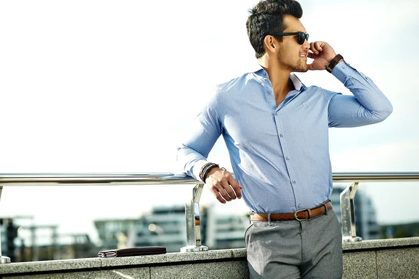 Fashion portrait of young sexy businessman handsome  model man in casual cloth suit in sunglasses in the street speaking on his phone — Stock Photo, Image