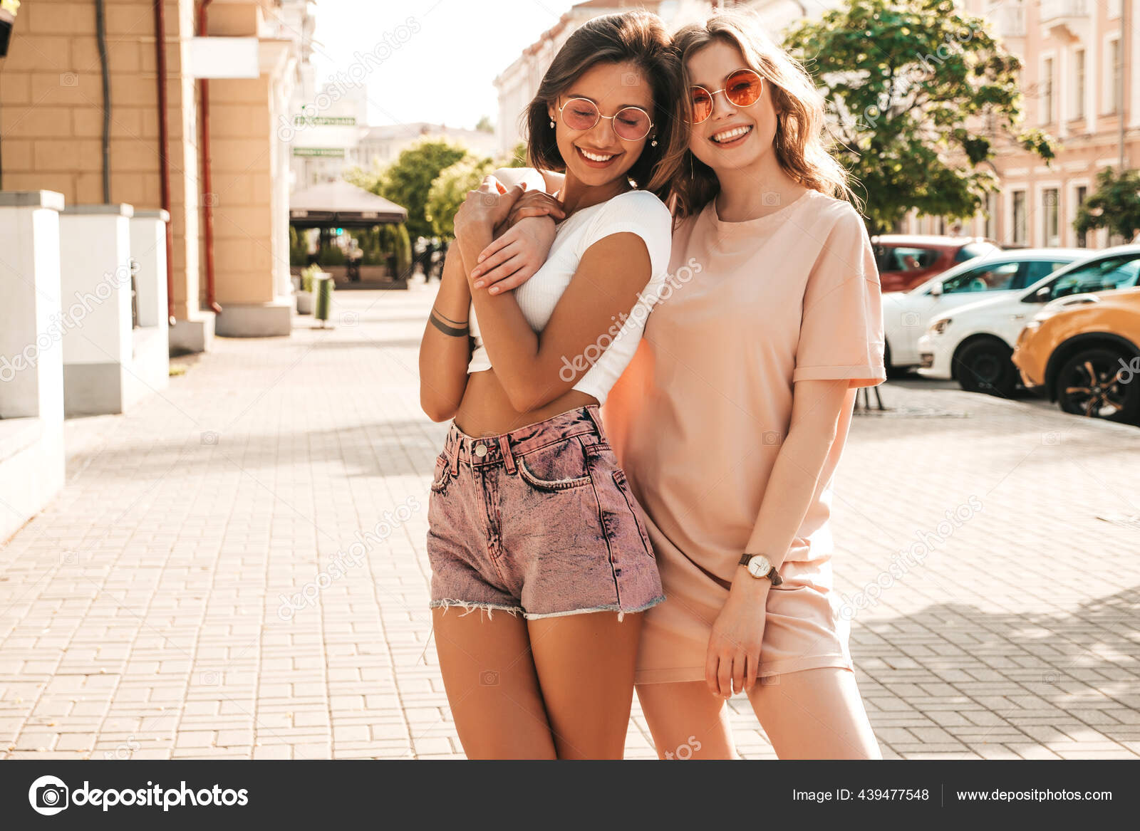Free Photo  Two young beautiful smiling hipster girls in trendy summer  clothes.sexy carefree women posing on street background in sunglasses.  positive models having fun and hugging