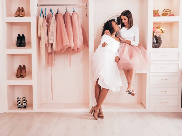 stock image Two young beautiful smiling international hipster female in trendy summer dresses. Sexy carefree women posing in pink wardrobe. Positive models having fun. They chatting and communicating