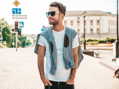Yakışıklı, gülümseyen stil sahibi Lambersex modelinin portresi. Beyaz tişört giyen adam. Moda erkeği güneş gözlükleriyle sokakta poz veriyor. 