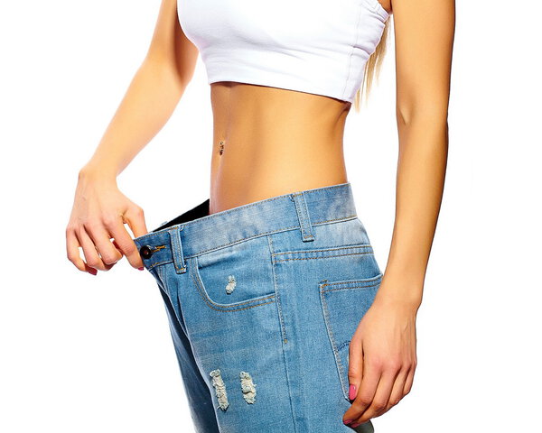 красивая молодая женщина с большими джинсами, изолированные на белом