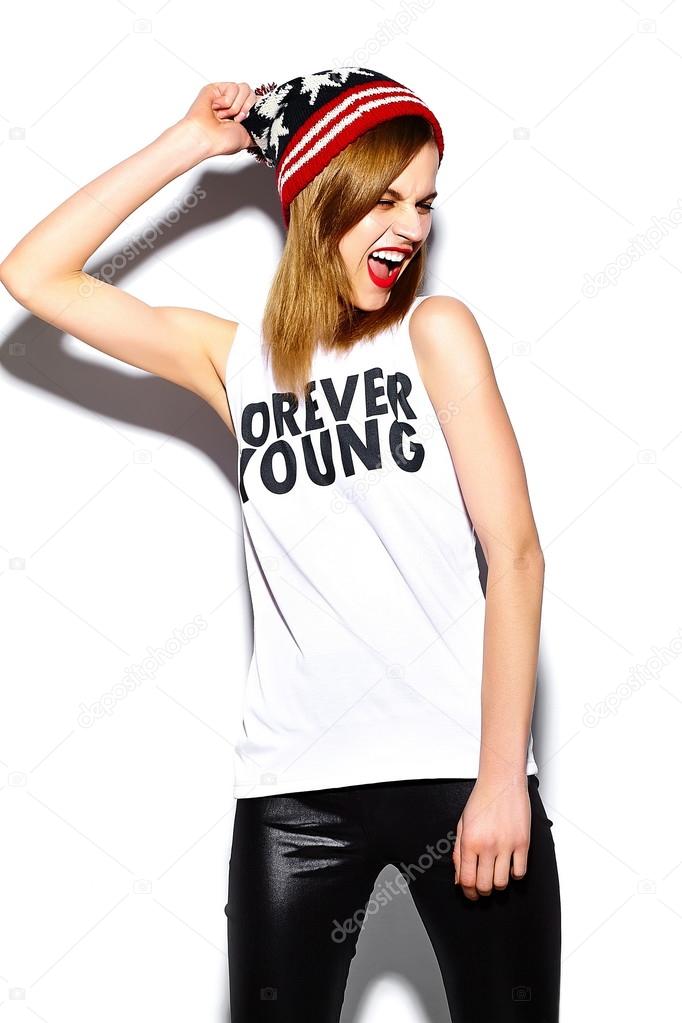 High fashion look.glamor stylish beautiful  young woman model with red lips  in hipster cloth in colorful beanie