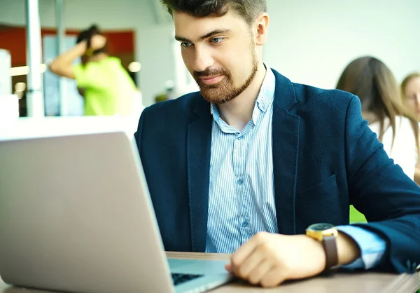 Young fashion smiling hipster man drinking  coffee in the city cafe during lunch time with notebook in suit — Φωτογραφία Αρχείου