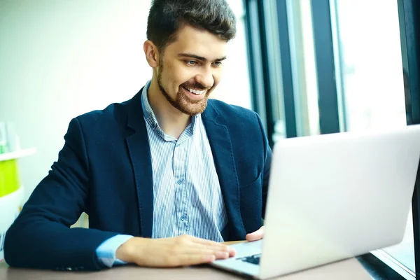 Young fashion smiling hipster man drinking  coffee in the city cafe during lunch time with notebook in suit — Φωτογραφία Αρχείου