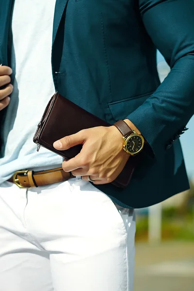 Fashion portrait of young businessman handsome  model man in casual cloth suit with accesories on hands