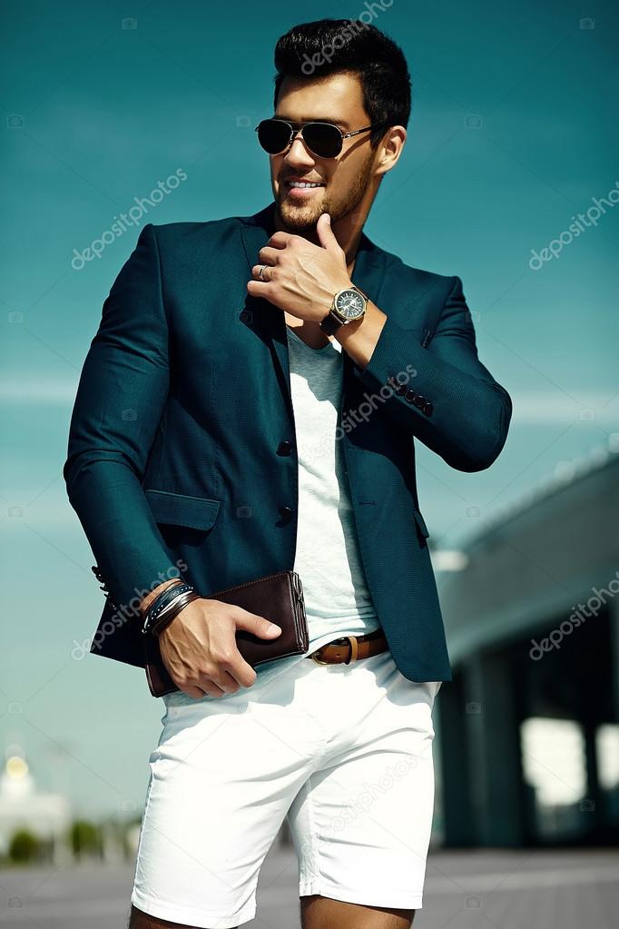 Fashion portrait of young sexy businessman handsome  model man in casual cloth suit in sunglasses in the street