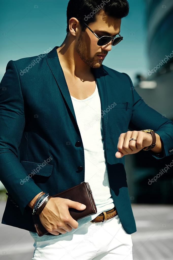 Fashion portrait of young sexy businessman handsome  model man in casual cloth suit in sunglasses in the street