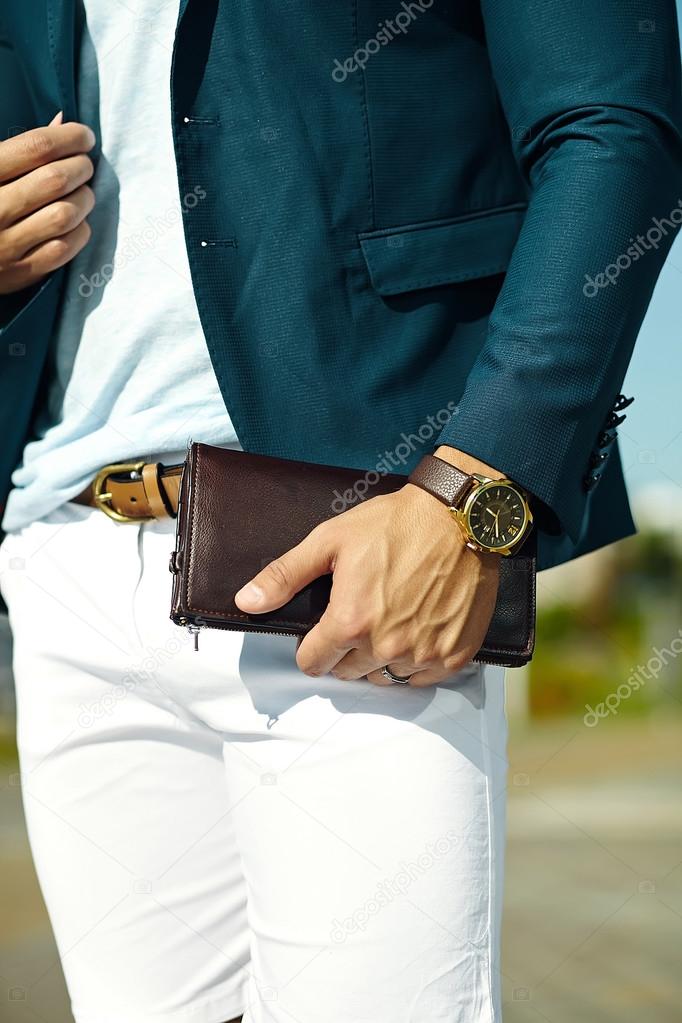 Fashion portrait of young businessman handsome  model man in casual cloth suit with accesories on hands