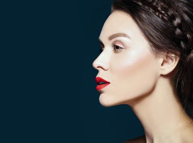 glamour portrait of beautiful  woman model lady with fresh daily makeup with red lips and clean face and romantic wavy hairstyle on brown background