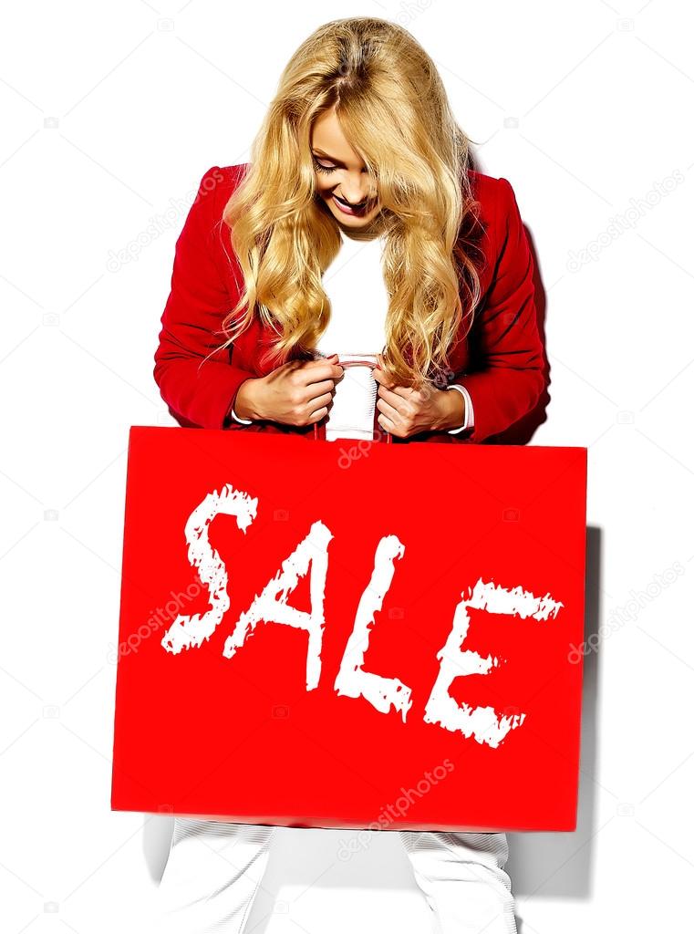 portrait of beautiful cute happy sweet surprised blonde woman girl holding in her hands big shopping bag in hipster red clothes isolated on white