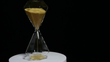 footage of sand clock dark background 