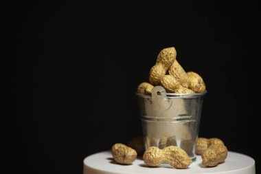 image of peanut bucket dark background 