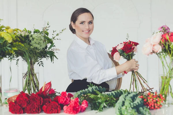 Beautiful happy florist woman at work