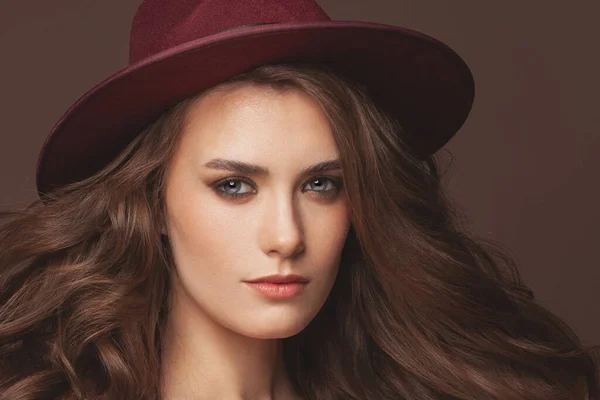 Lovely woman in red fedora hat portrait