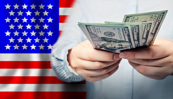 American dollars in hands. Coronavirus economic impact stimulus payments or IRS tax refun