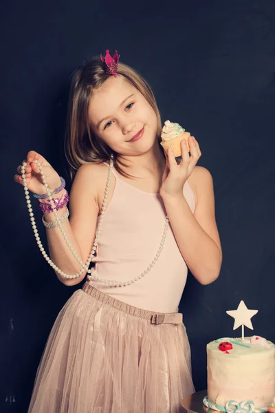 Young smiling girl with cupcake,  birthday card — Stock Photo, Image