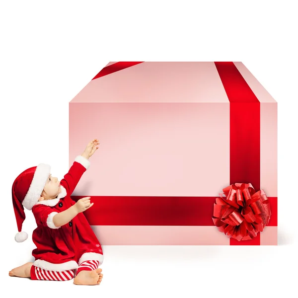 Kerstmis kind in Kerstman hoed en grote Gift Box. Xmas Concept op W — Stockfoto