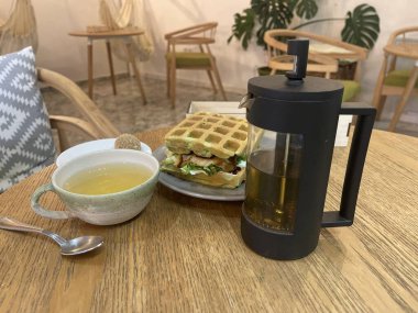 sandwich and tea on the table