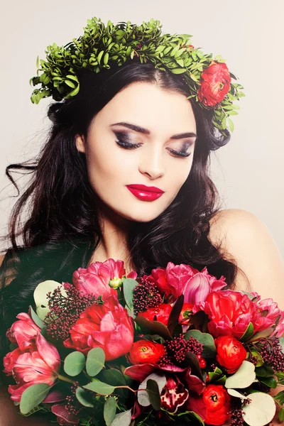 Beautiful Woman with Curly Hair, Makeup and Flowers