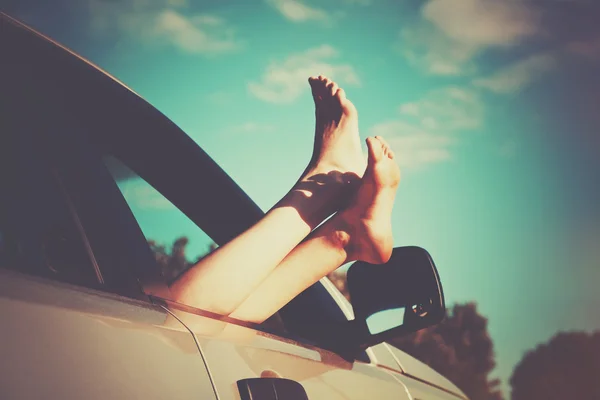 Des jambes de femme par la fenêtre de la voiture. Concept de liberté ou de voyage — Photo