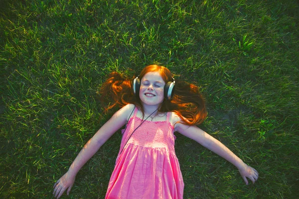 Redhead girl with headphones — Stock Photo, Image