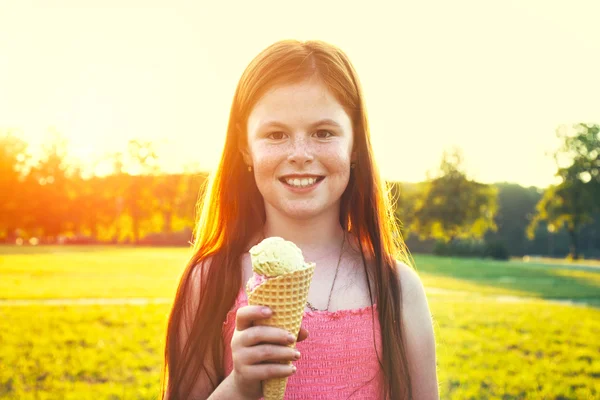 Redhead girl eating ice cream — Stock Photo, Image